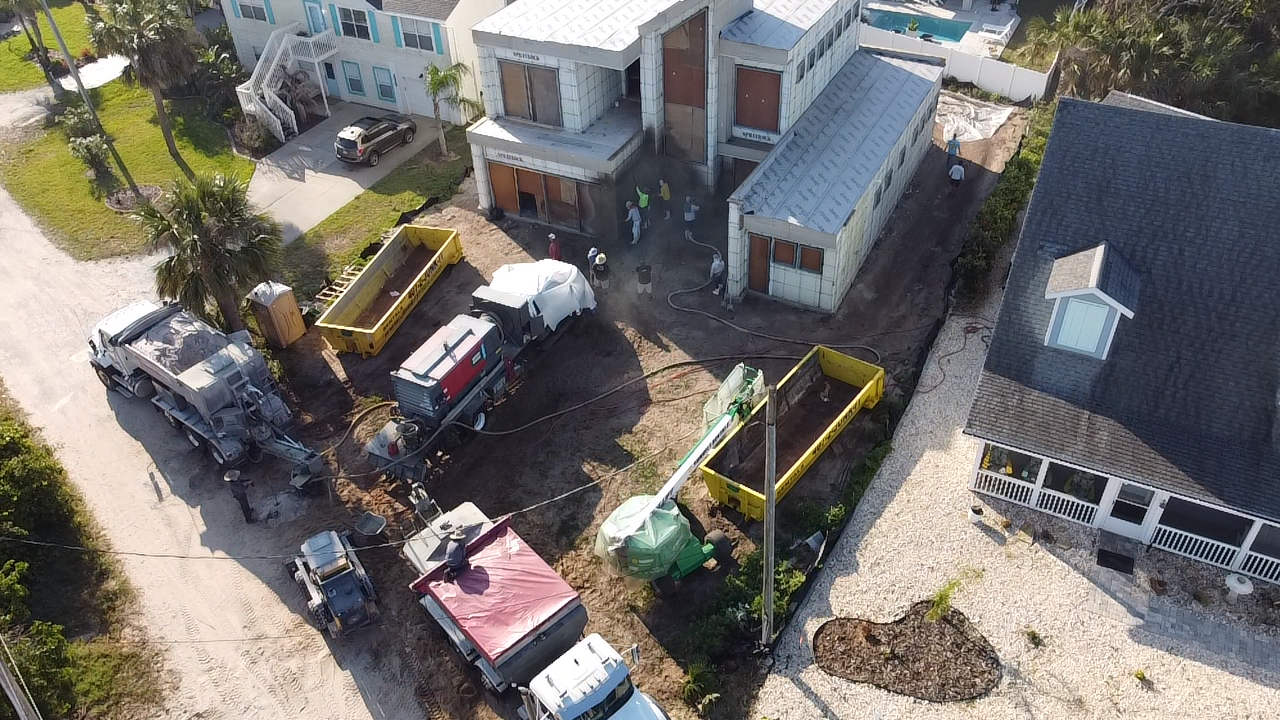 volumetric concrete mixers being used to pour the foundation on a residential concrete delivery project